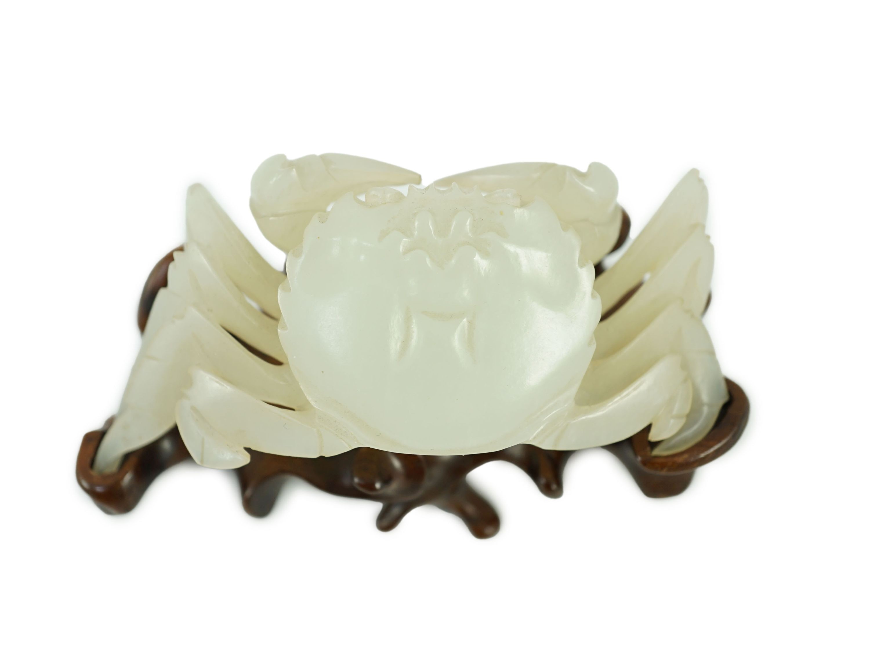 A Chinese pale celadon jade model of a crab, 20th century, 8.4 cm wide, wood stand